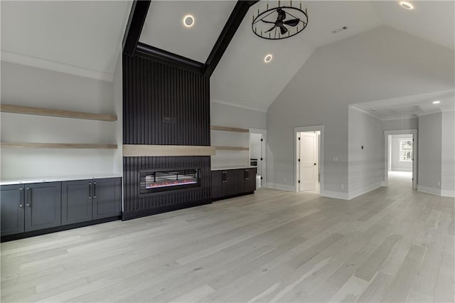 unfurnished living room featuring ornamental molding, high vaulted ceiling, and light hardwood / wood-style flooring