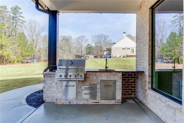 view of patio / terrace featuring area for grilling, a grill, and sink