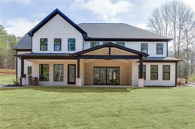 rear view of property featuring a lawn and a patio area