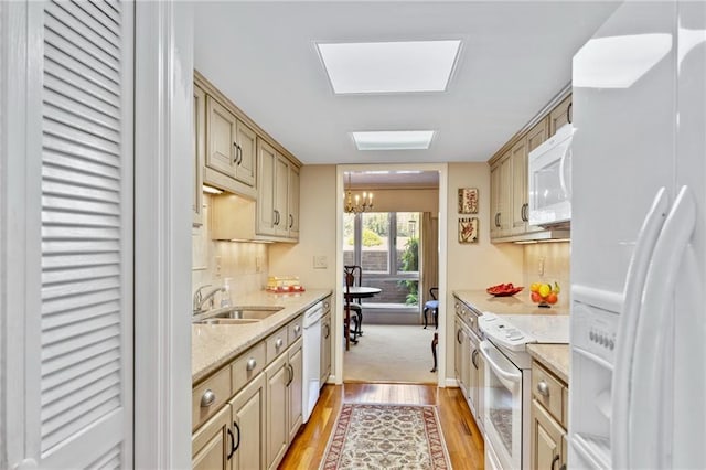 kitchen featuring white appliances, a chandelier, sink, light hardwood / wood-style flooring, and light brown cabinets