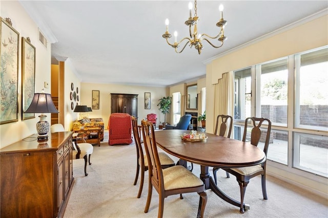 carpeted dining space featuring crown molding and a chandelier