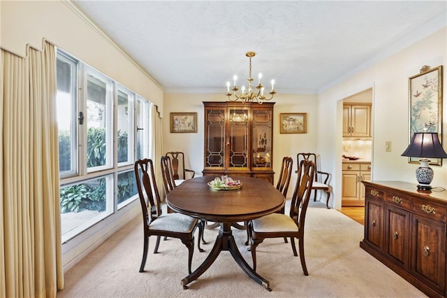 dining space with ornamental molding, light carpet, and a chandelier