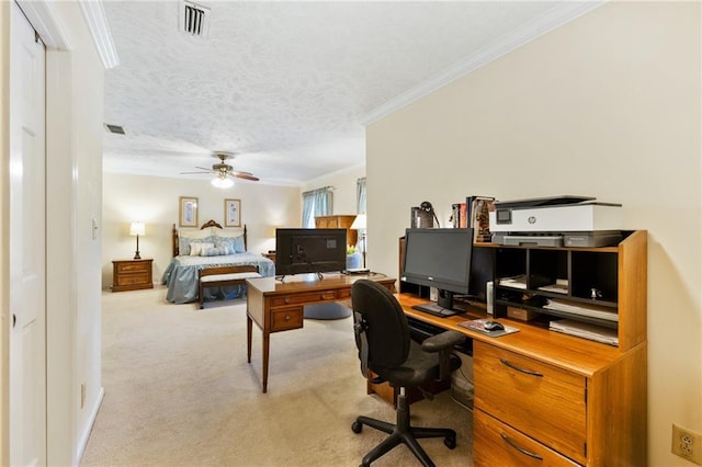 carpeted bedroom featuring ornamental molding and a textured ceiling