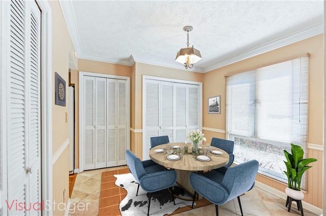 tiled dining space with crown molding and a textured ceiling