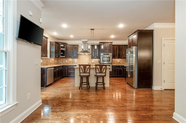2025 Eagle Rdg, Roswell, GA 30076 - kitchen with wall chimney exhaust hood, appliances with stainless steel finishes, dark brown cabinetry, a center island, and decorative backsplash