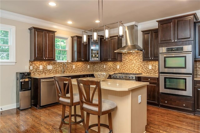 2025 Eagle Rdg, Roswell, GA 30076 - kitchen with wall chimney range hood, stainless steel appliances, dark brown cabinets, dark wood-style flooring, and crown molding