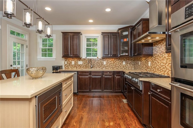 2025 Eagle Rdg, Roswell, GA 30076 - kitchen featuring appliances with stainless steel finishes, ornamental molding, wall chimney exhaust hood, dark wood-type flooring, and plenty of natural light