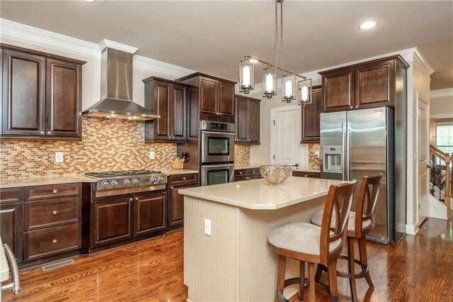 2025 Eagle Rdg, Roswell, GA 30076 - kitchen featuring appliances with stainless steel finishes, wall chimney range hood, crown molding, wood finished floors, and dark brown cabinetry