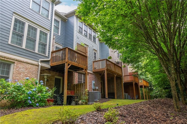 2025 Eagle Rdg, Roswell, GA 30076 - back of house featuring brick siding, cooling unit, and a wooden deck