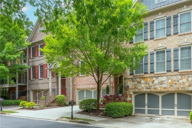 2025 Eagle Rdg, Roswell, GA 30076 - view of building exterior featuring driveway, stairs, and an attached garage