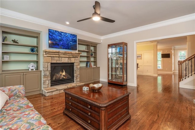 2025 Eagle Rdg, Roswell, GA 30076 - living room featuring a ceiling fan, stairs, a stone fireplace, crown molding, and wood finished floors