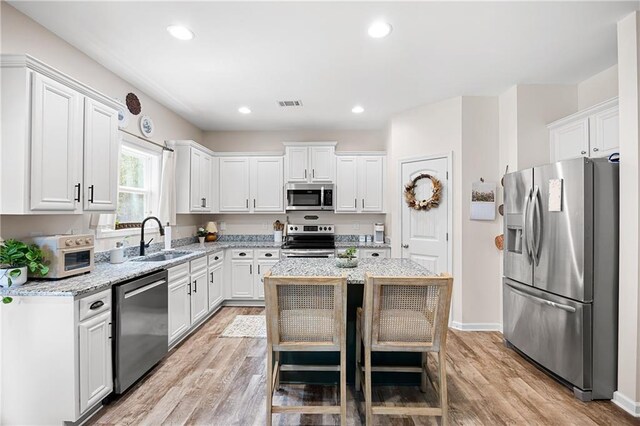 1417 Woodrow Kay Rd, Rockmart, GA 30153 - kitchen featuring appliances with stainless steel finishes, a sink, white cabinetry, a center island, and recessed lighting