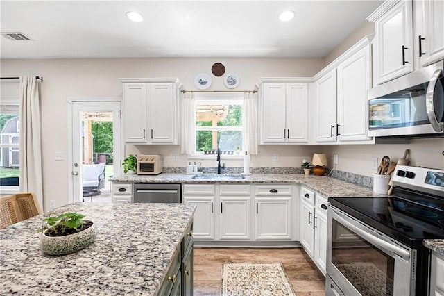 1417 Woodrow Kay Rd, Rockmart, GA 30153 - kitchen with stainless steel appliances, a sink, white cabinets, and recessed lighting