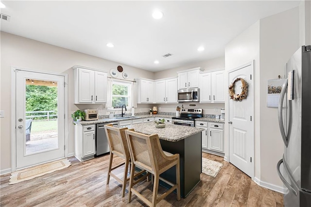 1417 Woodrow Kay Rd, Rockmart, GA 30153 - kitchen with appliances with stainless steel finishes, a sink, white cabinetry, a kitchen island, and recessed lighting