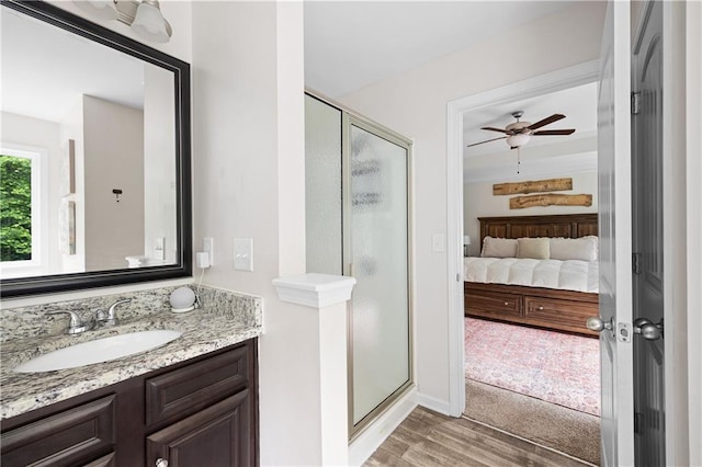 1417 Woodrow Kay Rd, Rockmart, GA 30153 - ensuite bathroom featuring a stall shower, wood finished floors, vanity, and a ceiling fan