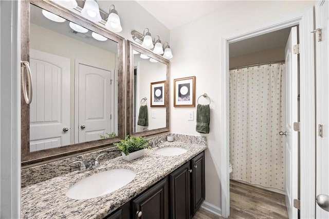 1417 Woodrow Kay Rd, Rockmart, GA 30153 - bathroom featuring wood finished floors, double vanity, toilet, and curtained shower