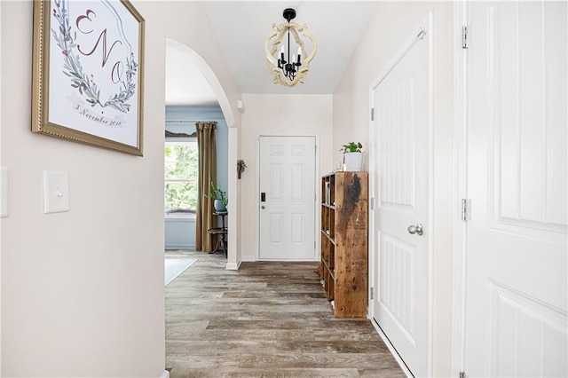1417 Woodrow Kay Rd, Rockmart, GA 30153 - foyer with a chandelier, arched walkways, wood finished floors, and baseboards