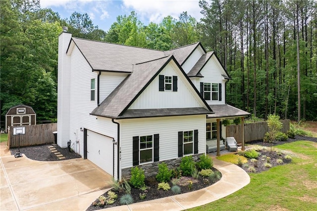 1417 Woodrow Kay Rd, Rockmart, GA 30153 - view of front of house featuring board and batten siding, concrete driveway, roof with shingles, a chimney, and stone siding