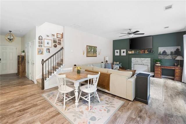 1417 Woodrow Kay Rd, Rockmart, GA 30153 - dining area featuring stairway, a ceiling fan, light wood finished floors, and a fireplace