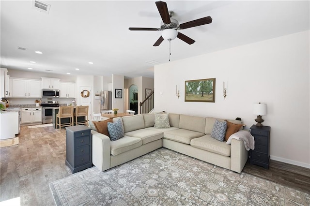1417 Woodrow Kay Rd, Rockmart, GA 30153 - living room featuring ceiling fan, light wood finished floors, stairs, recessed lighting, and baseboards