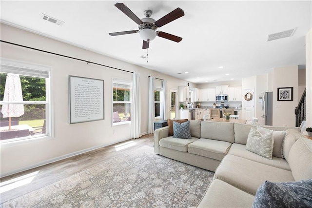 1417 Woodrow Kay Rd, Rockmart, GA 30153 - living room with light wood-style flooring, a ceiling fan, baseboards, stairs, and recessed lighting