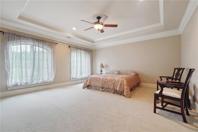 carpeted bedroom with ceiling fan, a raised ceiling, and crown molding