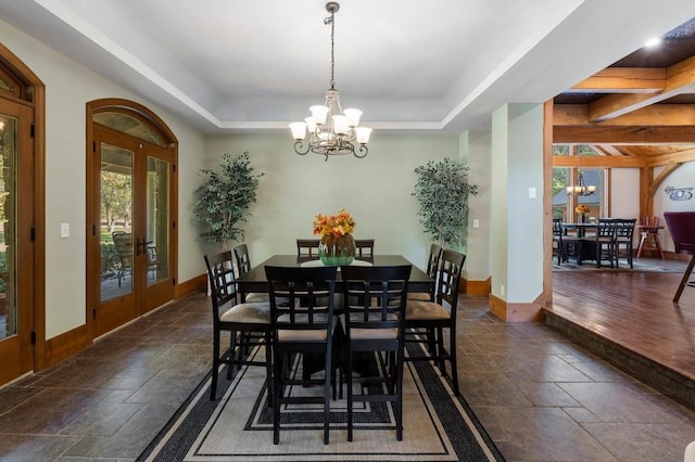 dining area featuring french doors, dark hardwood / wood-style flooring, and a chandelier