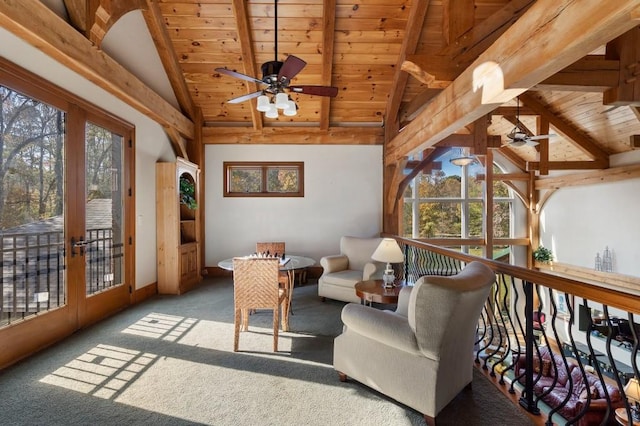 sunroom with vaulted ceiling with beams, wooden ceiling, plenty of natural light, and ceiling fan