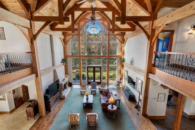 unfurnished sunroom featuring lofted ceiling with beams, wooden ceiling, and ceiling fan