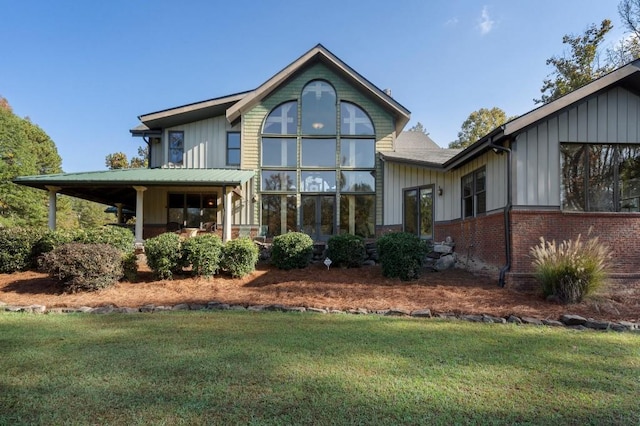 rear view of property with a yard