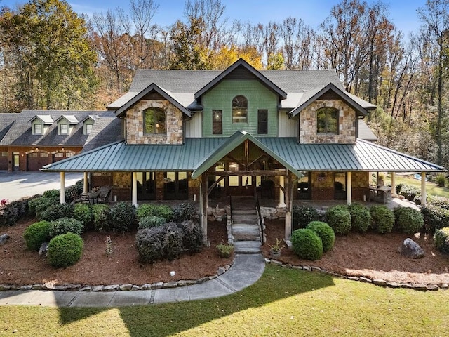 view of front of home with a porch and a front yard