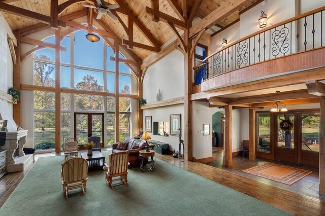 interior space with wood ceiling, a healthy amount of sunlight, and lofted ceiling with beams