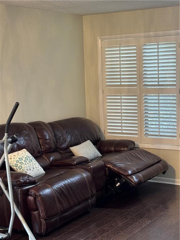 living area with a textured ceiling and wood finished floors