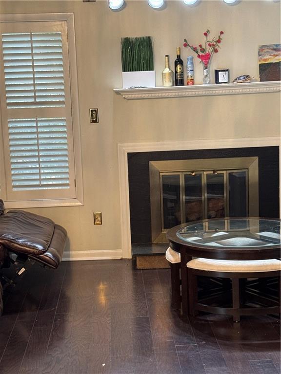 living area with wood finished floors and baseboards