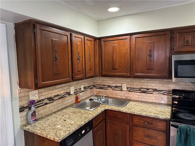 kitchen with decorative backsplash, recessed lighting, appliances with stainless steel finishes, a textured ceiling, and a sink