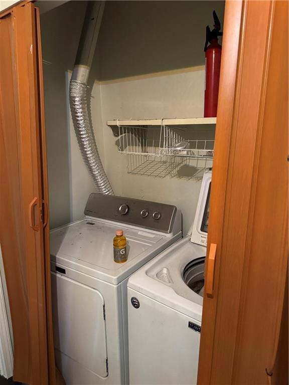 laundry area with laundry area and washer and clothes dryer