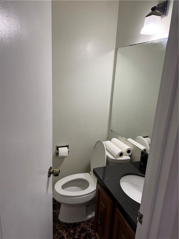 bathroom featuring marble finish floor, toilet, and vanity