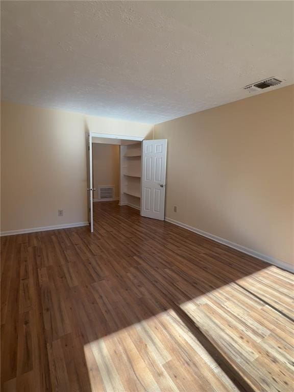 empty room with hardwood / wood-style floors