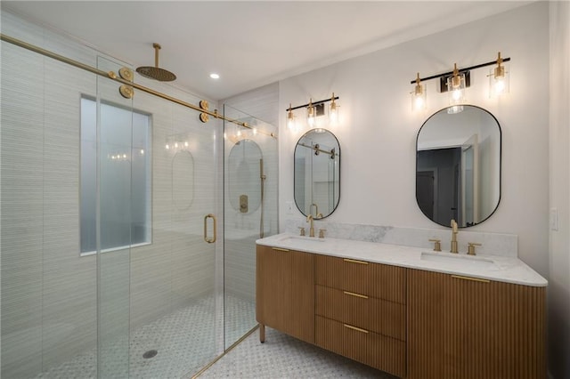 bathroom with double vanity, a stall shower, and a sink