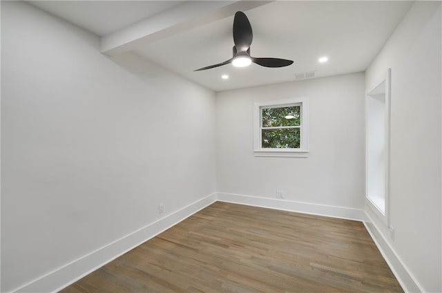 unfurnished room with a ceiling fan, baseboards, visible vents, and wood finished floors