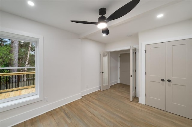 unfurnished bedroom featuring recessed lighting, a closet, light wood-style flooring, and baseboards