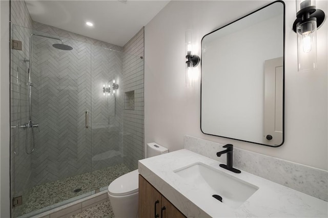 full bath with vanity, a shower stall, toilet, and recessed lighting