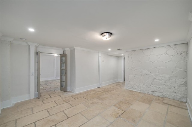 empty room with ornamental molding, recessed lighting, stone tile flooring, and baseboards