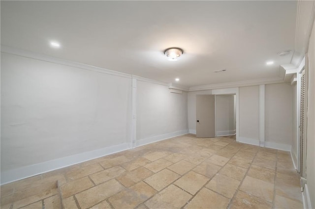 finished basement featuring baseboards, ornamental molding, stone tile flooring, and recessed lighting