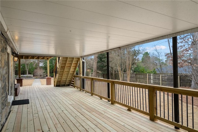 wooden deck featuring a fenced backyard and stairway