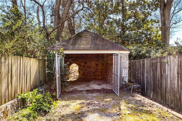 view of outbuilding featuring a fenced backyard and an outbuilding