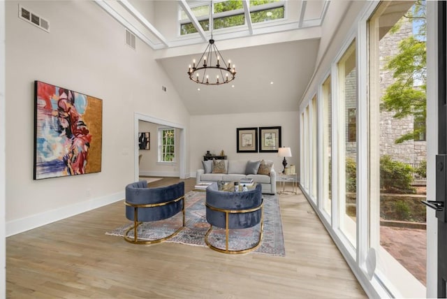 490 Rock Springs Rd NE, Atlanta, GA 30324 - living area with a towering ceiling, light wood-style flooring, a chandelier, and visible vents