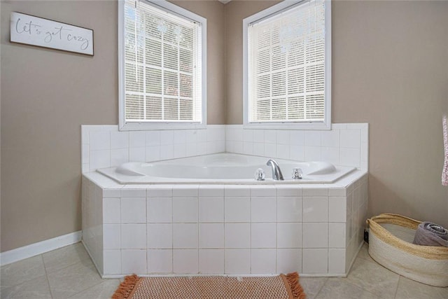 bathroom with tiled bath and tile patterned floors