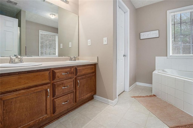 bathroom featuring vanity and tiled tub