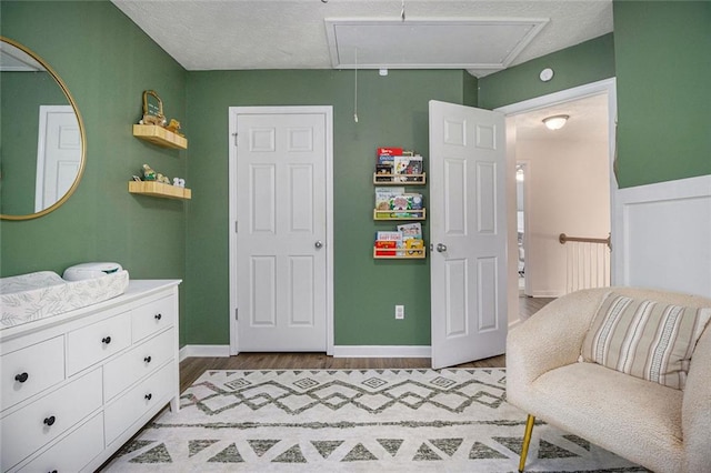 bedroom with wood-type flooring and a textured ceiling